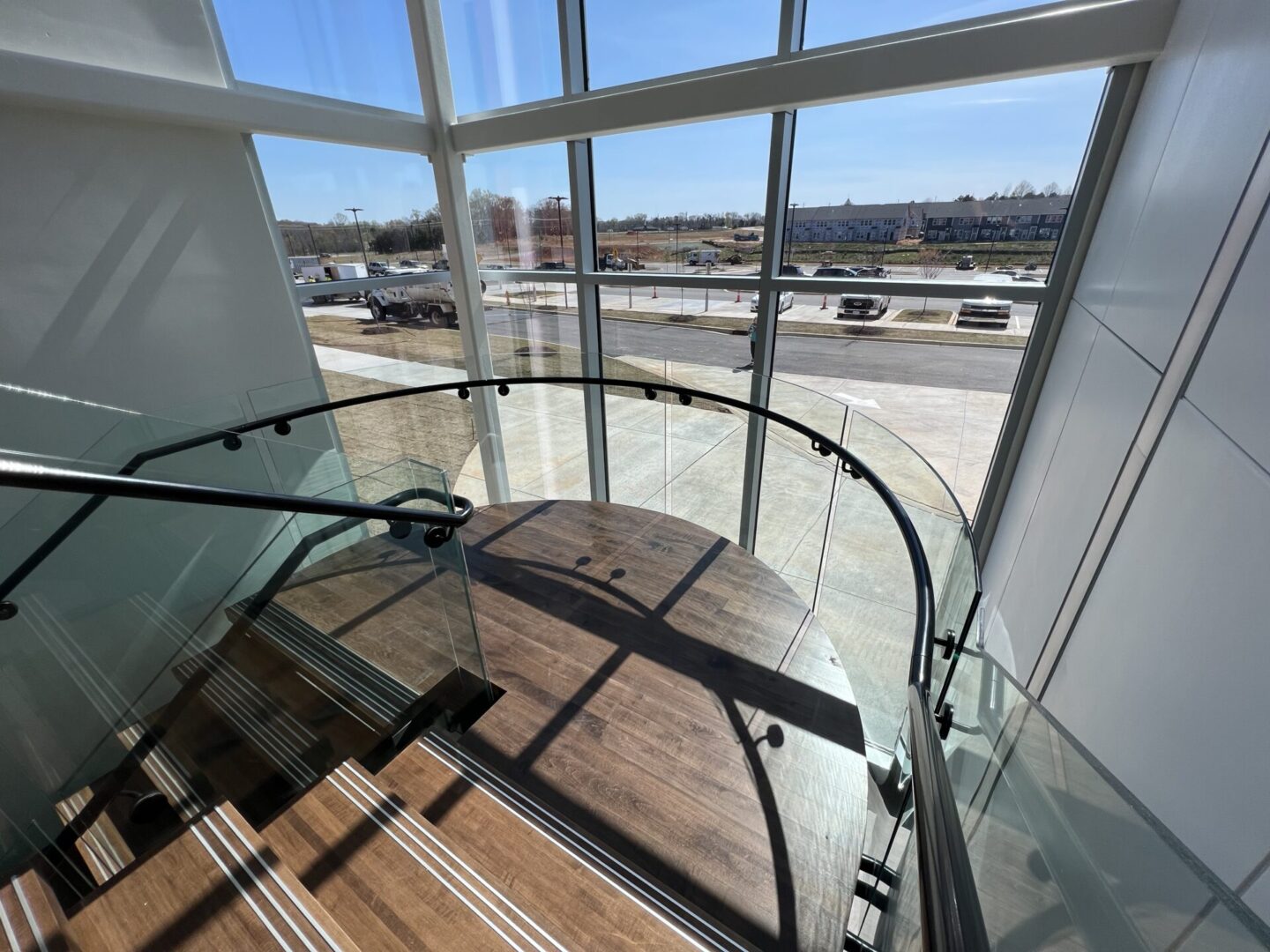 A staircase glass with metal brace handrails
