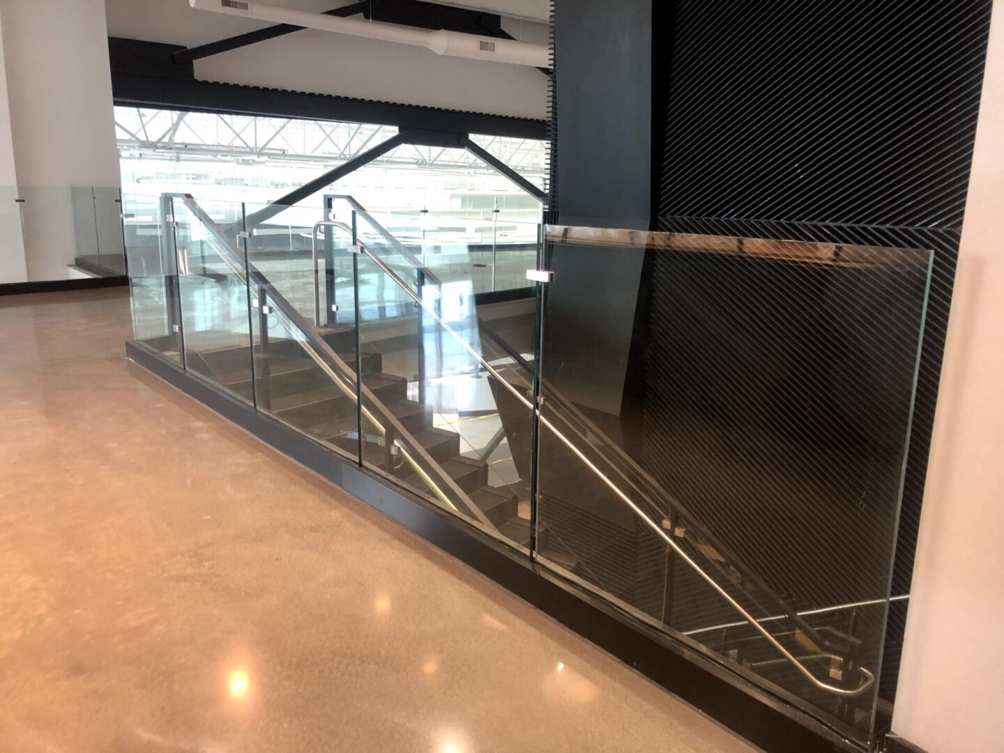 A White Tiled Glazing Floor Case With Glass Railing