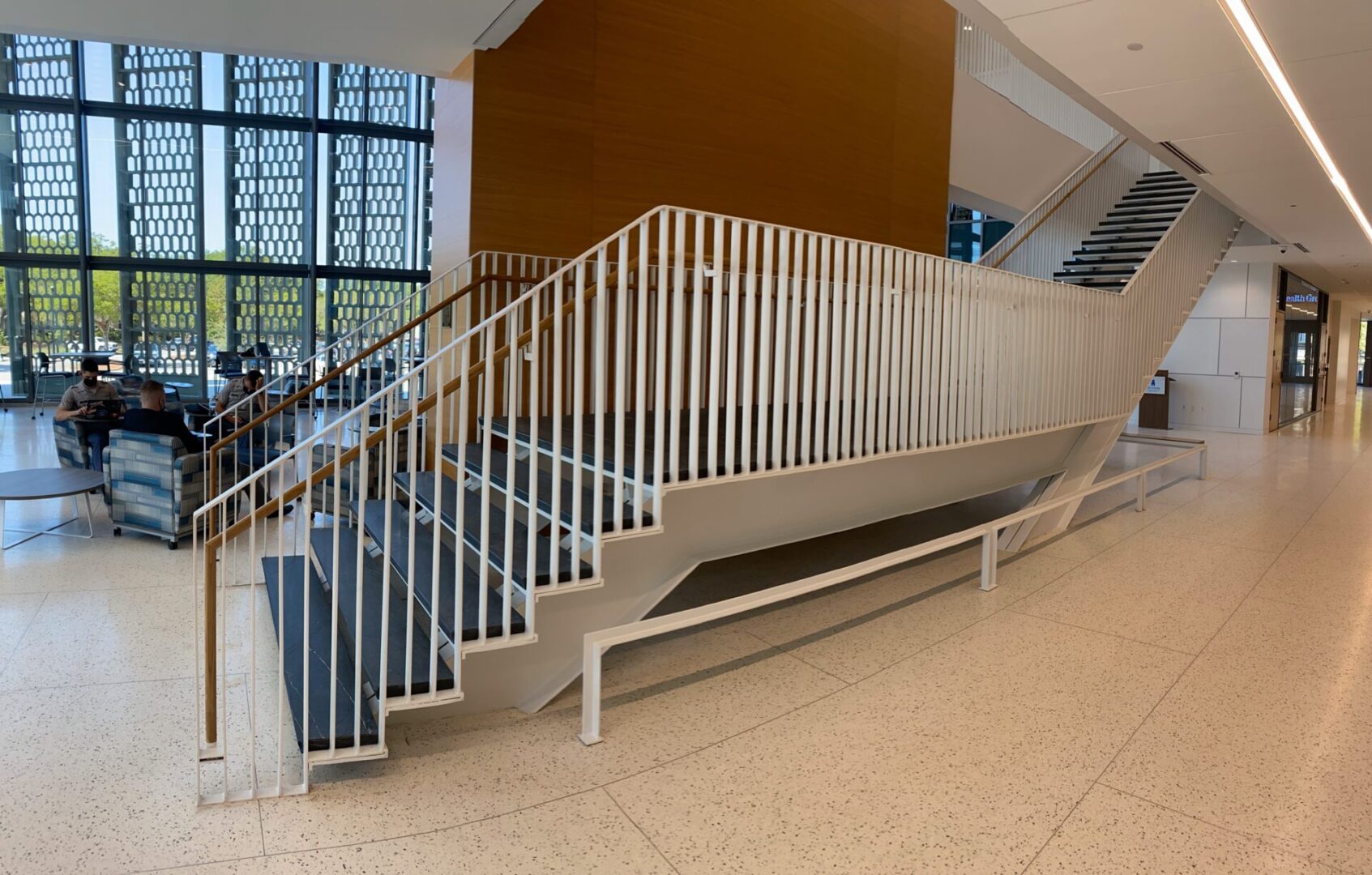 A staircase with white and brown metal handrails