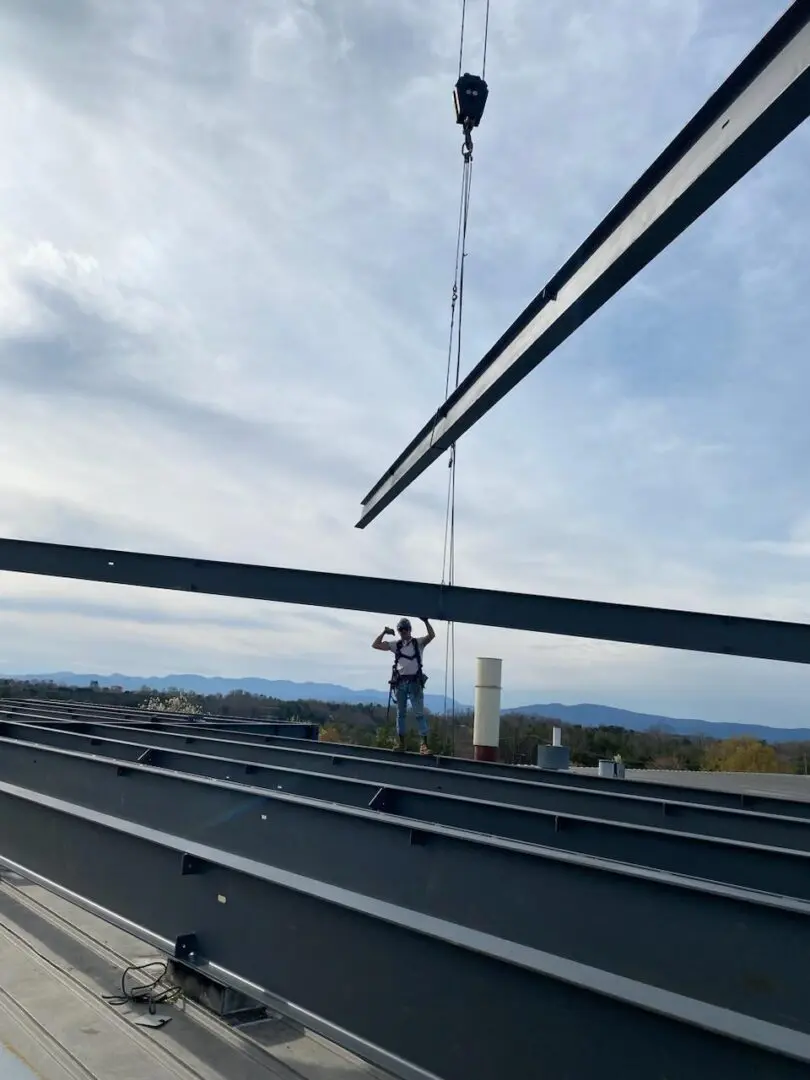 A worker standing on top of steel beams